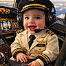 airplane, aviation, baby, captain, child, clouds, cockpit, cute, flight_controls, hands, happy, hat, headset, pilot, portrait, seat, sky, smiling, tie, uniform