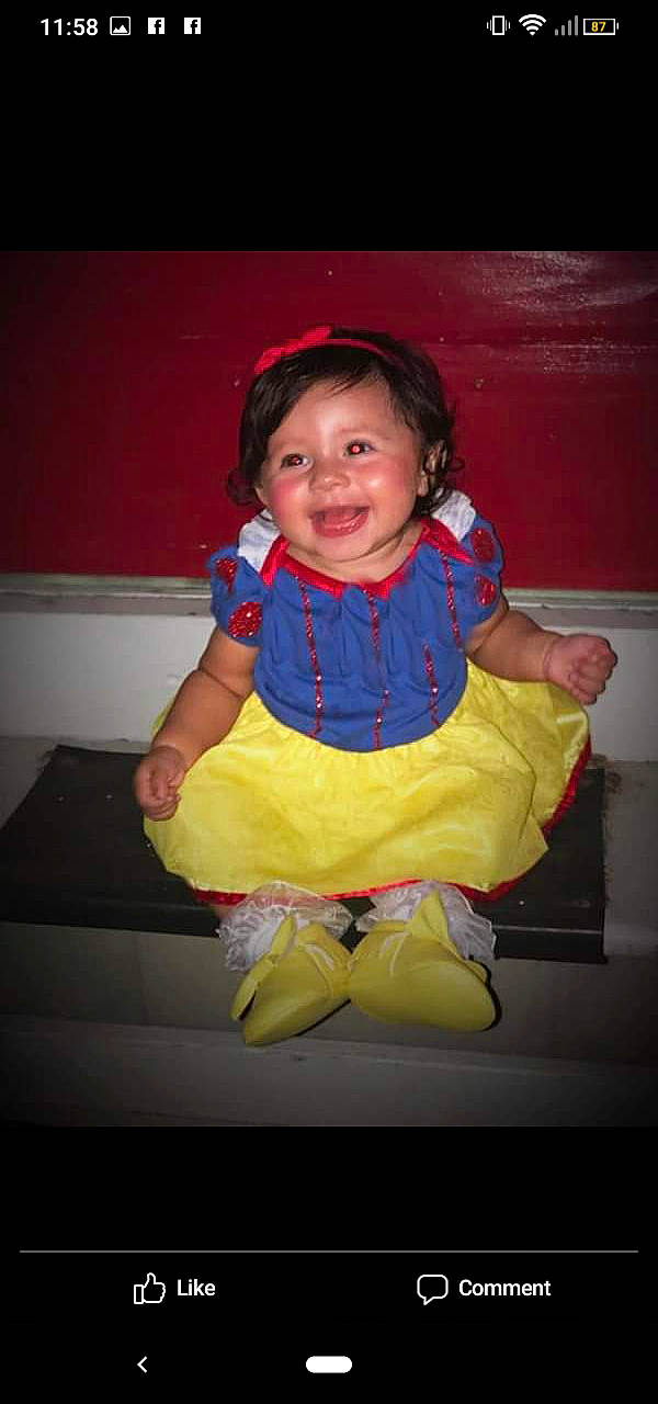 Tatiana is registered to the contest to win money with this photo: cheek, child, costume, facial_expression, fun, happy, outerwear, person, sitting, smile, toddler, yellow