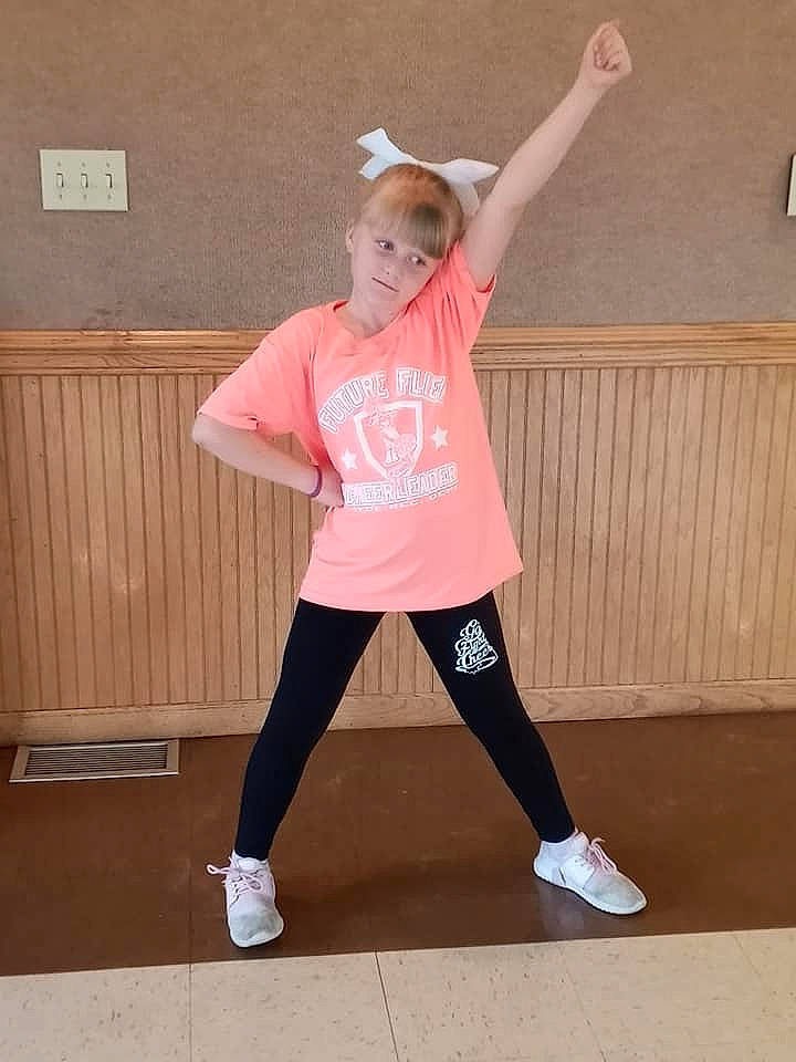 Trinity is registered to the contest to win money with this photo: abdomen, active_pants, balance, dance, exercise, flooring, happy, human_leg, knee, performing_arts, person, recreation, shoe, sleeve, sportswear, sweatpant, t_shirt, thigh, trunk, waist