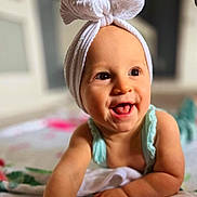 Sophia is registered to the contest to win money with this photo: accessories, baby, babylaughing, clothing, face, happy, head, headband, person, photography, portrait, scarf, smile