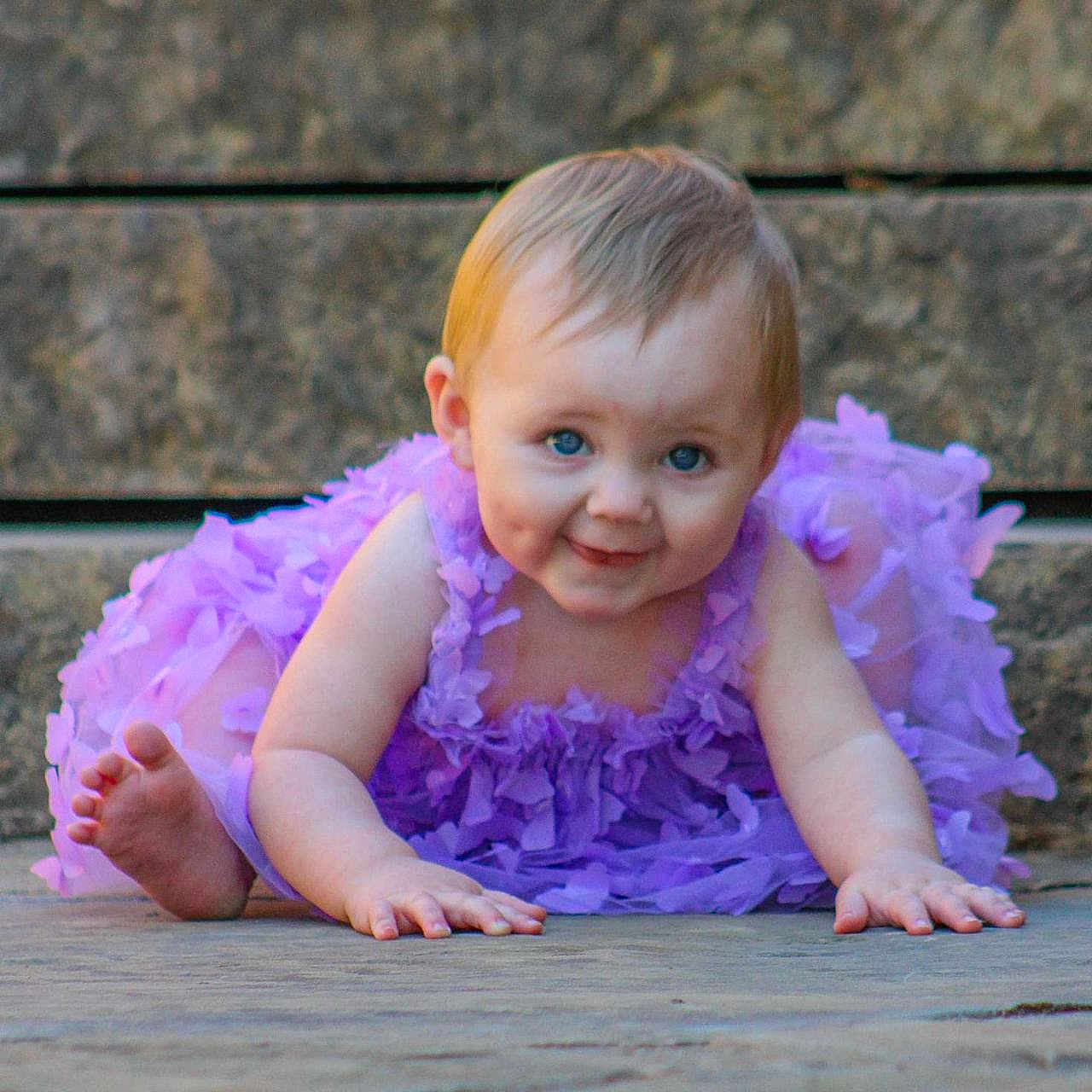 Oakley joined the competition — help win amazing prizes! accessories, baby, barefoot, bodypart, clothing, costume, crawling, dress, face, finger, flower, head, person, petal, photography, plant, portrait, purple, sitting, wood