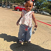 Ahbri is registered to the contest to win money with this photo: blue_pants, braided_hair, cars, child, outdoor, parking_lot, pavement, person, playful, red_bows, sandals, shadow, smile, sunglasses, sunlight, sunny, toddler, trees, white_flower_clips, white_top
