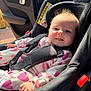 baby, car_seat, child, infant, seatbelt, car_interior, sunlight, happy, smiling, clothing, heart_pattern, hair, safety, seat, window, daylight, person, cute, transportation, indoors