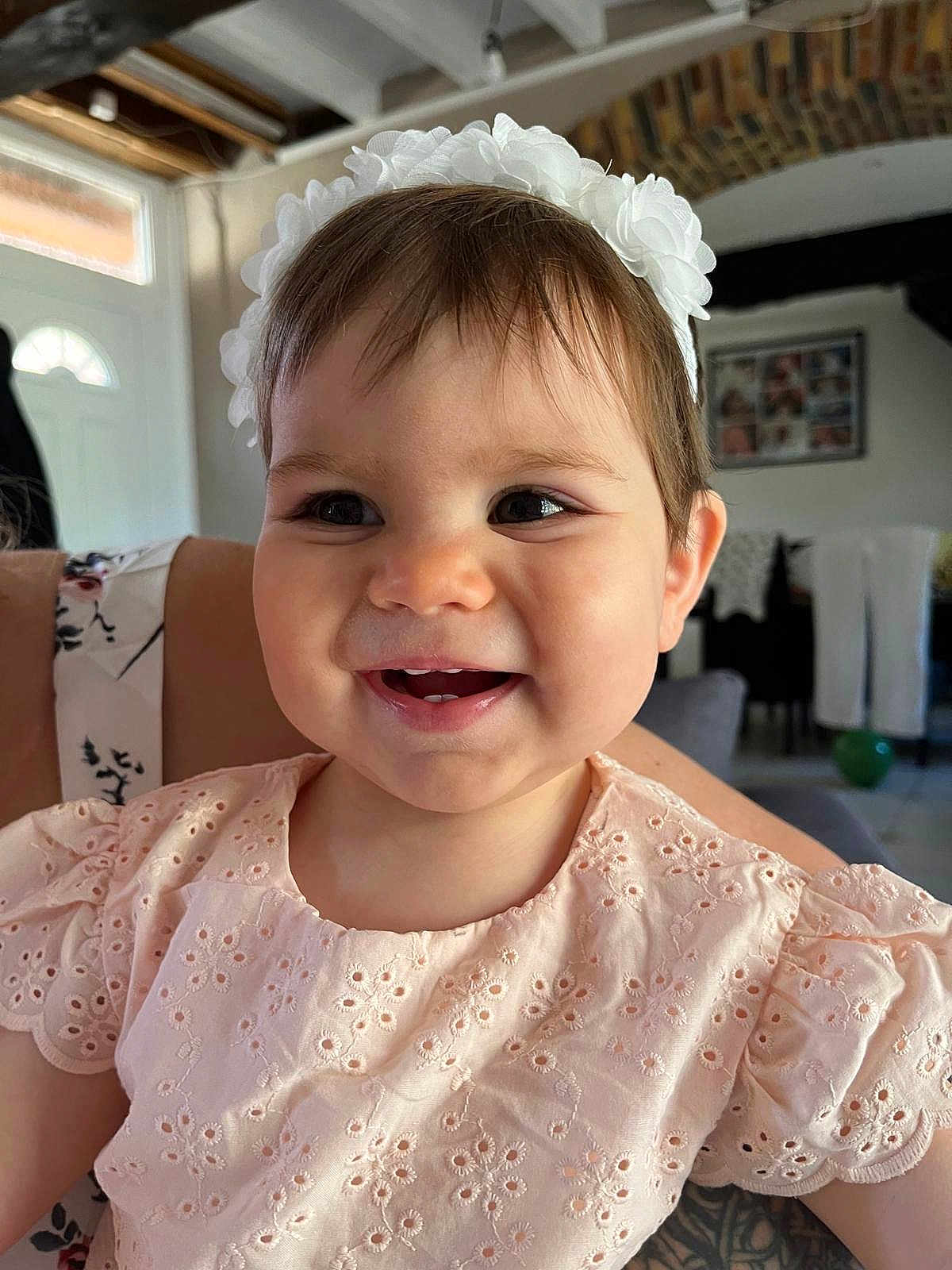 Aerys participe au concours pour gagner de l'argent avec cette photo : baby, cheerful, child, closeup, clothing, cute, eyelet_fabric, face, happy, headband, home, indoor, infant, natural_light, person, pink_dress, portrait, smiling, toddler, white_flower