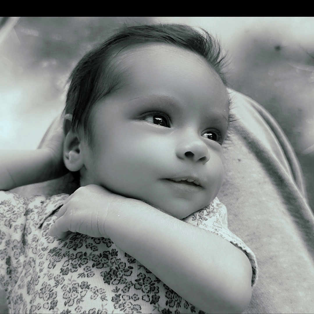 Zoriya is registered to the contest to win money with this photo: arm, baby, black_and_white, blanket, calm, child, close_up, cozy, cushion, eyes, face, floral_clothing, hair, indoor, infant, lying_down, monochrome, patterned_clothing, photography, portrait