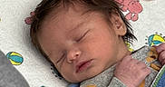 Zoriya is registered to the contest to win money with this photo: baby, baby_clothing, bed, blanket, close_up, closed_eyes, cozy, crib, face, gray_sweater, indoors, infant, newborn, peaceful, pink_blanket, plush_toy, portrait, sleeping, stuffed_animal, swaddled
