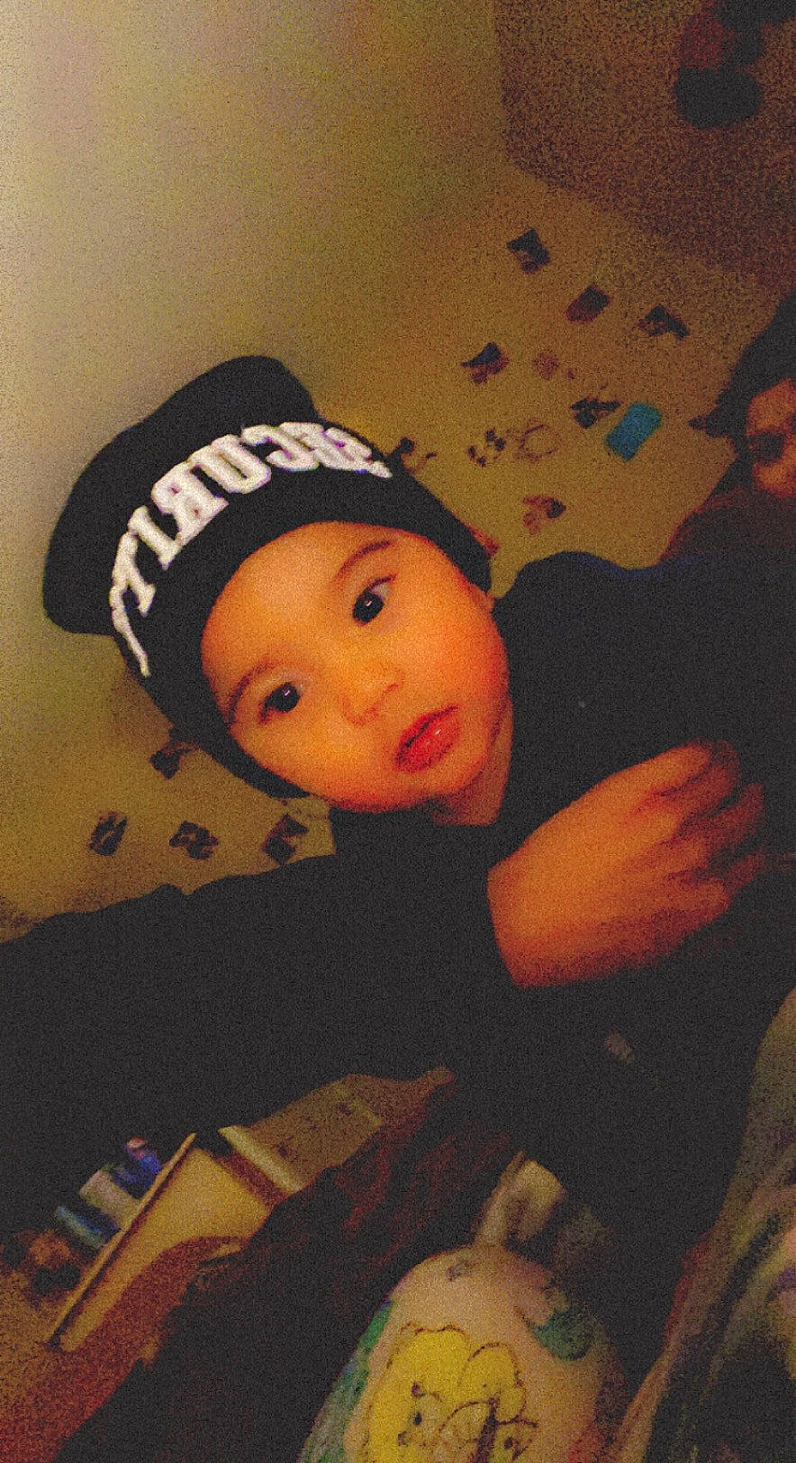 Alejandro joined the competition — help win amazing prizes! baby, baby_toddler_clothing, beanie, cap, cheek, child, comfort, cool, flash_photography, flooring, fun, happy, headgear, headwear, pattern, person, personal_protective_equipment, room, sitting, toddler