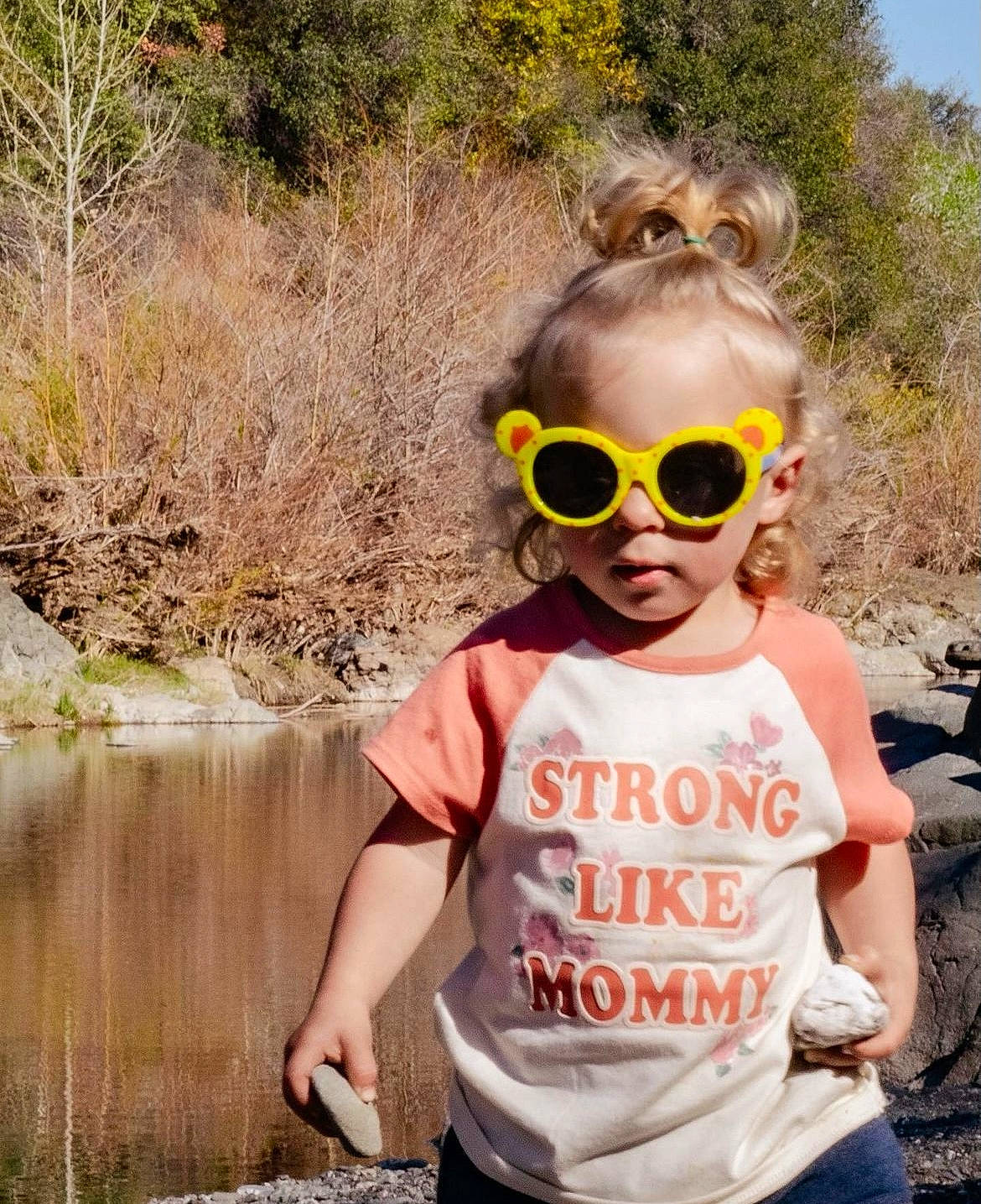 Adalynn is registered to the contest to win money with this photo: child, cool, eyewear, fashion_accessory, fun, glasses, goggles, grass, happy, leaf, leisure, morning, person, personal_protective_equipment, plant, sleeve, sunglasses, t_shirt, toddler, tree