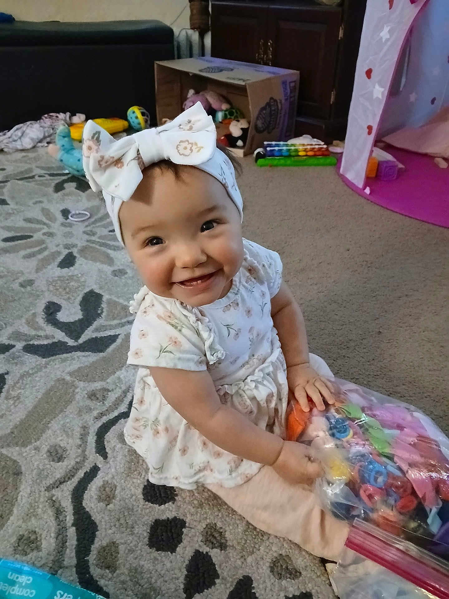 Annalee joined the competition — help win amazing prizes! baby, bag, cabinet, carpet, child, childhood, colorful, couch, cute, dress, floor, happy, headband, indoor, playroom, smiling, stuffed_animal, tent, toy, xylophone