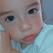 Emily is registered to the contest to win money with this photo: toddler, child, close_up, face, eyes, expression, skin, arm, white_shirt, portrait, innocent, resting, soft_light, indoor, young_child, person, cute, baby, head, curly_hair