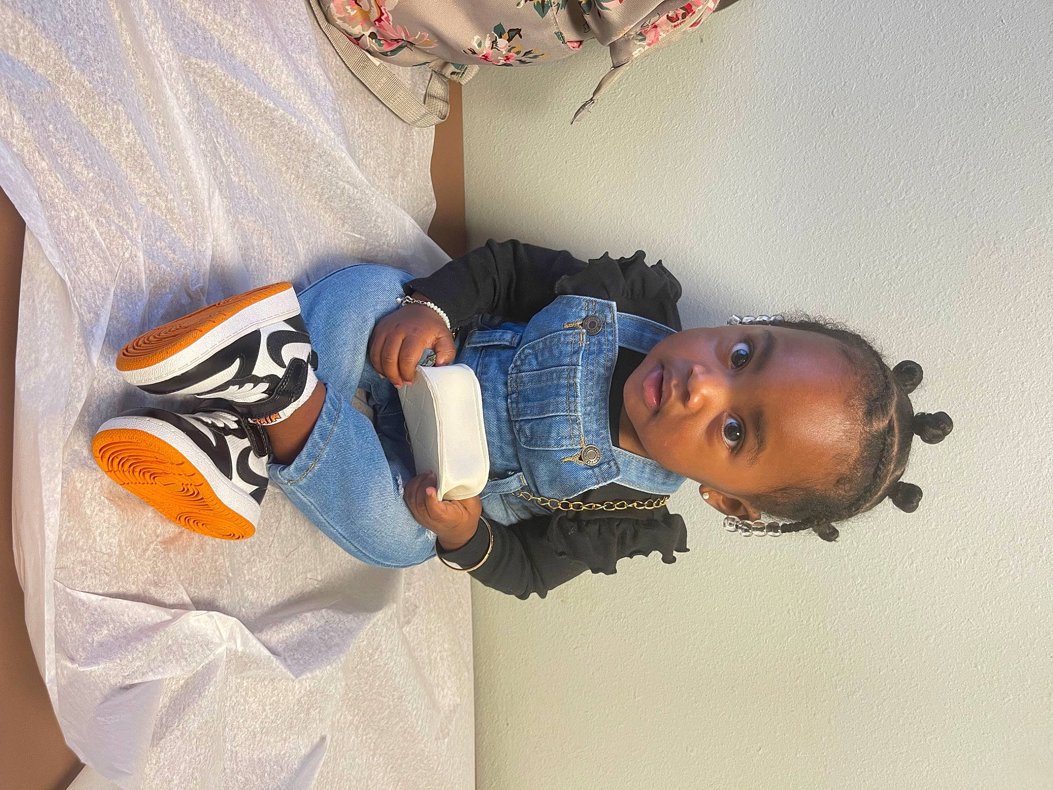 Milani is registered to the contest to win money with this photo: arm, baby_toddler_clothing, child, denim, elbow, electric_blue, hand, jersey, jewellery, linens, pattern, person, room, sleeve, sportswear, t_shirt, toddler, top, uniform, wrist