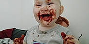 Caspian joined the competition — help win amazing prizes! baby, child, messy, chocolate, food, happy, smile, face, hands, tshirt, indoor, person, cute, playful, toddler, expression, young, fun, dirt, clothing