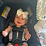 Maaliyah is registered to the contest to win money with this photo: baby, car_seat, child, smiling, headband, bow, plush_toy, unicorn, straps, safety, infant, cute, happy, indoors, clothing, seatbelt, toy, child_safety, portrait, person