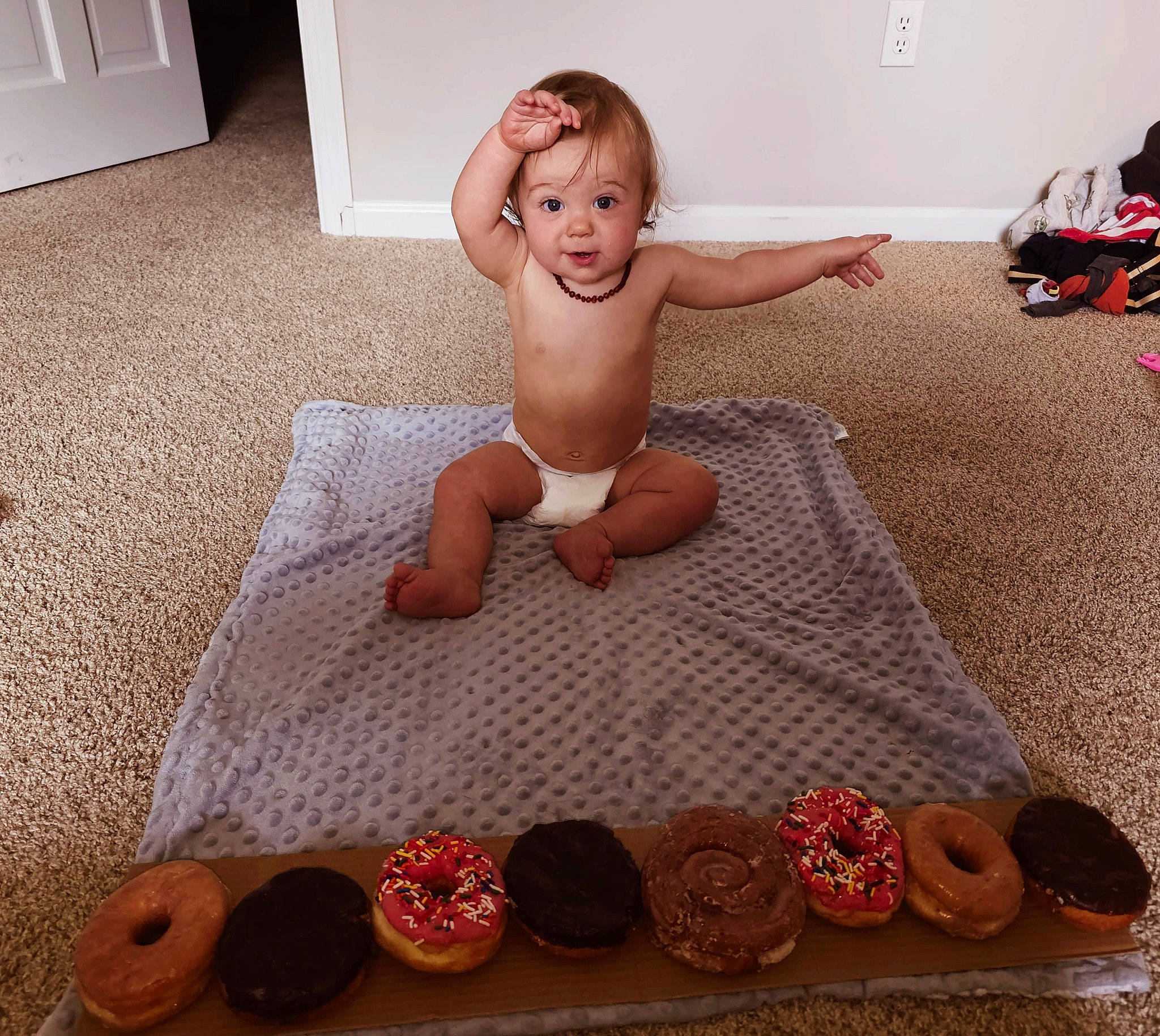 Izabella is registered to the contest to win money with this photo: baby, baked_goods, barefoot, bathing, chest, child, comfort, cuisine, floor, flooring, foot, happy, human_leg, linens, person, room, sitting, smile, thigh, toddler