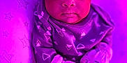 Lyliah joined the competition — help win amazing prizes! baby, infant, headband, bow, mittens, pillow, stars, purple_light, cozy, clothing, cute, portrait, indoors, soft_texture, young_child, sitting, expression, face, person, blanket