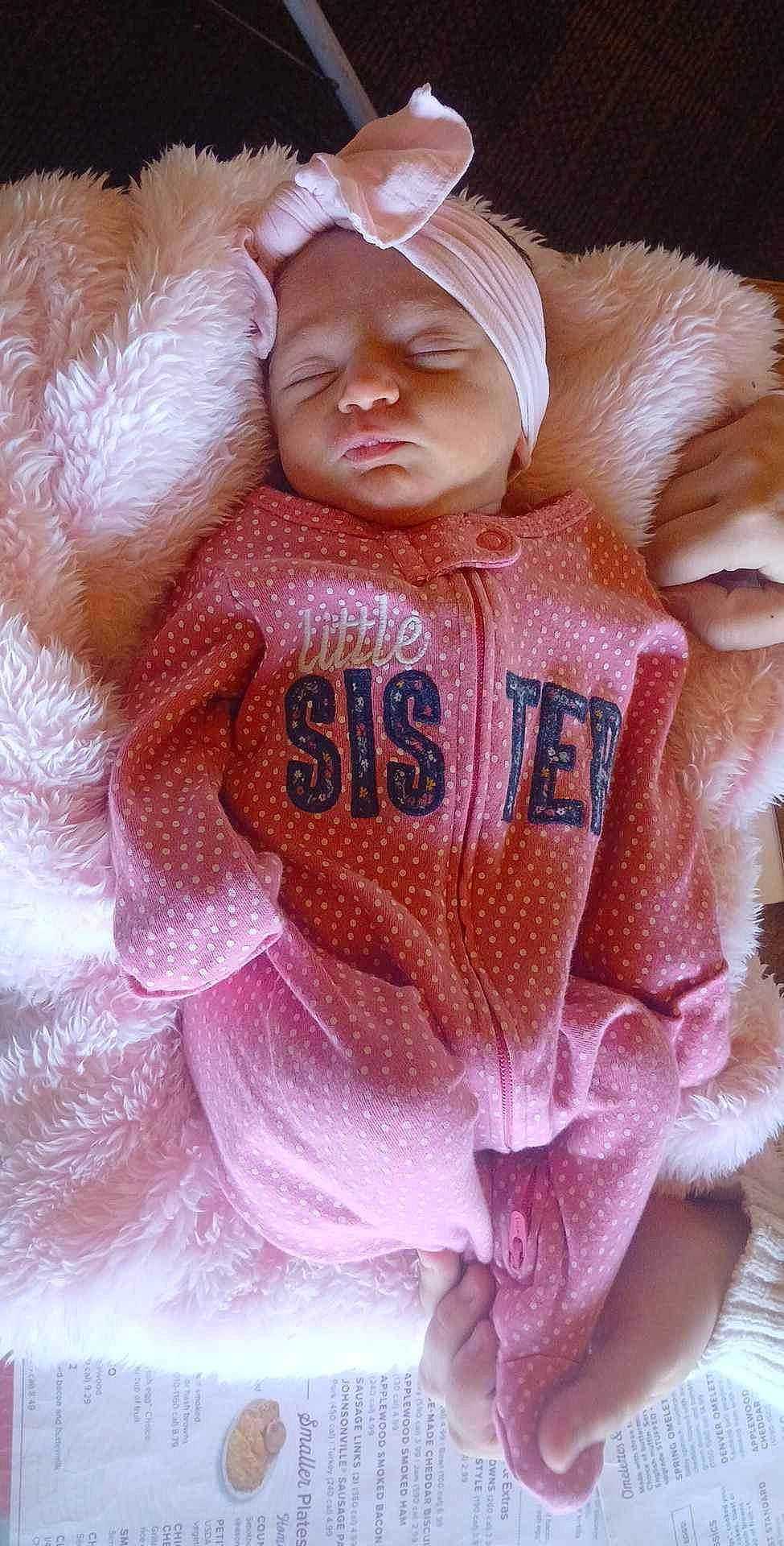 Olivia joined the competition — help win amazing prizes! baby, bed, blanket, bonnet, cap, clothing, coat, face, furniture, hat, head, jacket, newborn, person, photography, portrait, quilt, sleeping, t_shirt, text