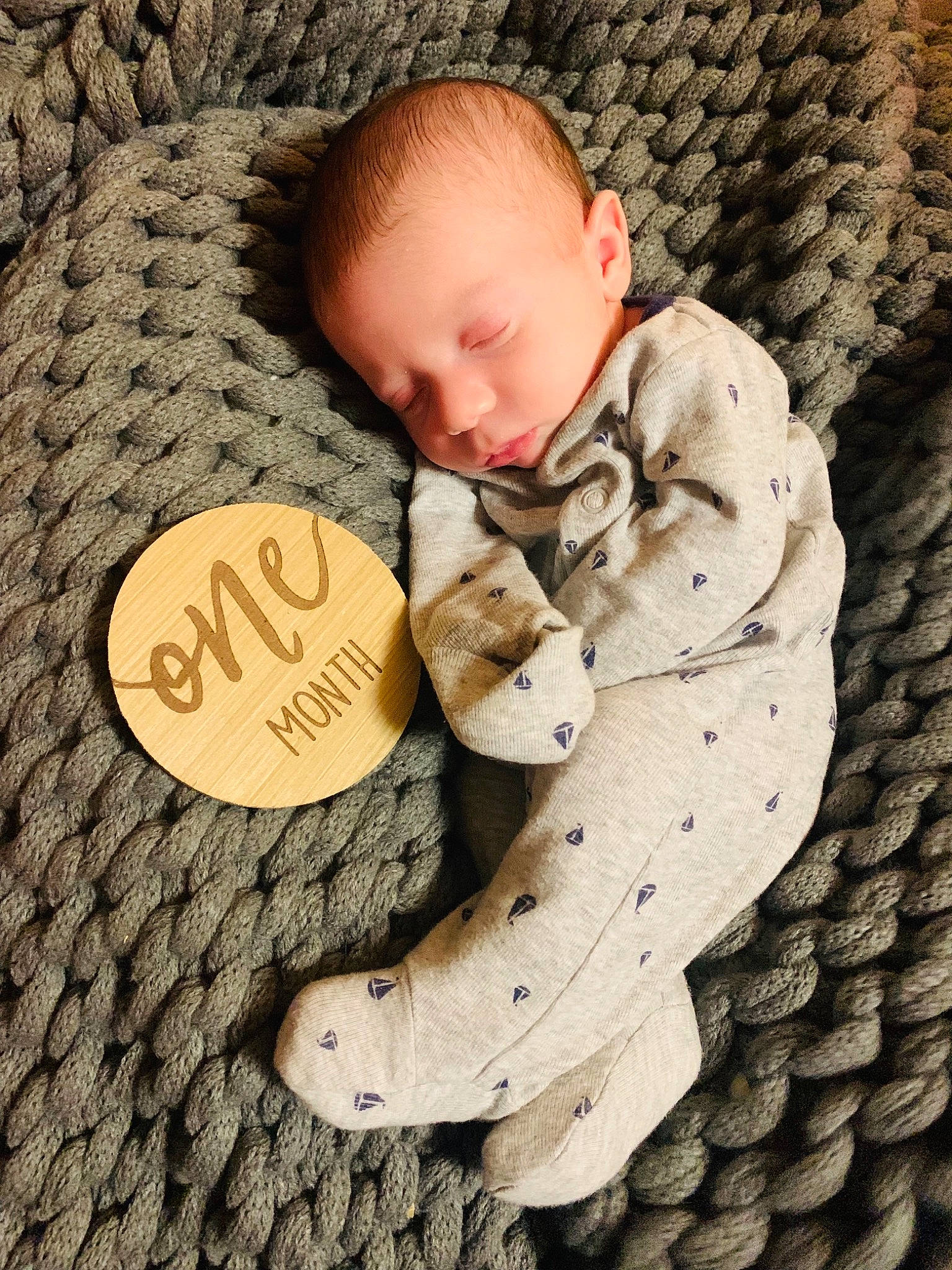 Hagen joined the competition — help win amazing prizes! baby, baby_sleeping, baby_toddler_clothing, child, comfort, font, grass, grey, hand, happy, headgear, linens, mammal, pattern, people_in_nature, person, sitting, toddler, tree, vertebrate