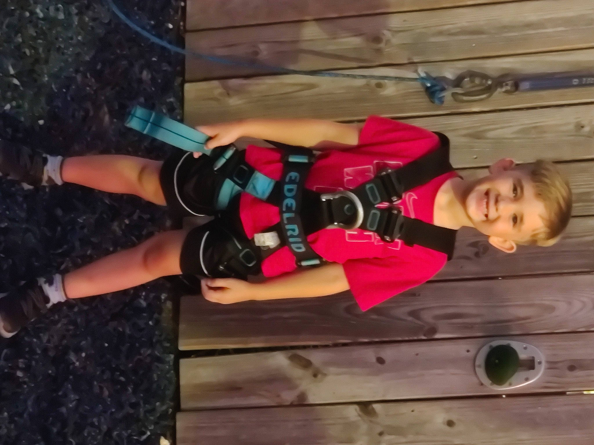 Killian is registered to the contest to win money with this photo: chest, elbow, fun, glove, hardwood, human_leg, joy, knee, leisure, person, recreation, shorts, smile, sportswear, thigh, wood, wrist