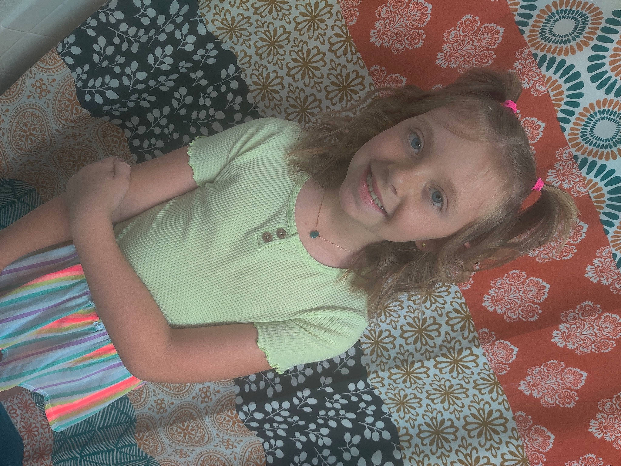 Peighton is registered to the contest to win money with this photo: baby_toddler_clothing, beauty, child, comfort, cool, finger, fun, hairstyle, happy, human_body, human_leg, joy, linens, organ, pattern, person, pink, room, skin, smile