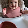 Ellie joined the competition — help win amazing prizes! baby, high_chair, bib, food, smile, happy, child, face, messy, pink, feeding, meal, indoor, person, cute, tongue, hand, infant, expression, seat