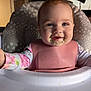 baby, bib, high_chair, messy, food, face, smiling, child, infant, pink, clothing, indoor, person, happy, feeding, cute, portrait, young, seat, table