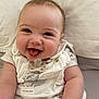 Ellie is registered to the contest to win money with this photo: baby, baby_bib, baby_blanket, child, chubby_cheeks, closeup, clothing, cute, happy, indoor, infant, lying_down, pacifier, person, portrait, skin, smiling, soft_background, tongue_out, white_outfit