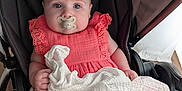 Ellie is registered to the contest to win money with this photo: baby, baby_clothing, blue_eyes, child, childcare, closeup, comfort, coral_dress, cute, furniture, hand, indoors, infant, legs, pacifier, portrait, seat_belt, soft_skin, stroller, white_cloth