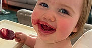 Ellie joined the competition — help win amazing prizes! baby, child, cute, eating, food, furniture, hand, happy, high_chair, indoor, living_room, messy_face, person, playful, popsicle, rosy_cheeks, skin, smile, toddler, young_child