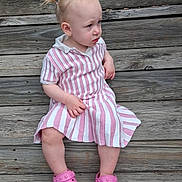 Fiona joined the competition — help win amazing prizes! toddler, child, pink_crocs, striped_dress, wooden_steps, outdoor, sitting, curious_expression, pony_tail, footwear, person, casual_clothing, summer, daylight, young_child, portrait, wood_texture, planks, candid, cute
