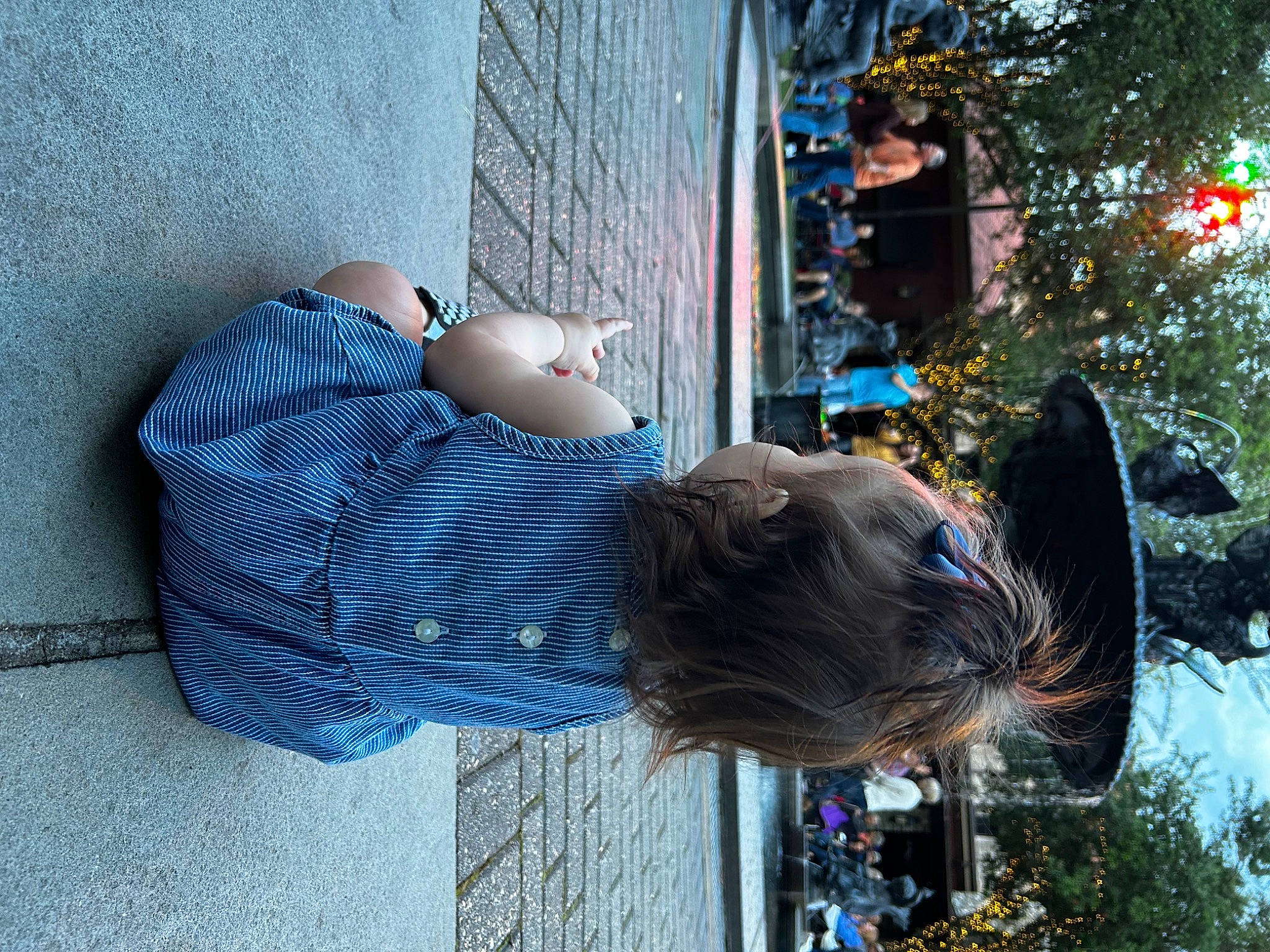 Elsie is registered to the contest to win money with this photo: blue, child, denim, fun, leisure, pedestrian, person, plant, sitting, street, tree, vacation, wood