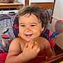 toddler, child, smiling, messy_face, curly_hair, high_chair, food, indoor, happy, cute, person, baby, eating, colorful, furniture, hand, table, closeup, portrait, skin