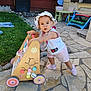 toddler, child, toy, walker, hat, outdoor, patio, stone, grass, woman, table, chair, colorful, shoes, sunhat, curious, play, person, casual, daylight
