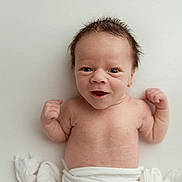 Archer is registered to the contest to win money with this photo: baby, newborn, infant, smiling, arms, flexing, hair, blanket, white, skin, cute, portrait, lying_down, expression, young, child, happy, face, person, toddler