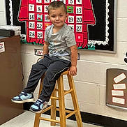 Steven joined the competition — help win amazing prizes! child, boy, smile, stool, classroom, calendar, september, wall, shoes, pants, tshirt, hair, floor, furniture, education, indoor, young, cute, happy, sitting
