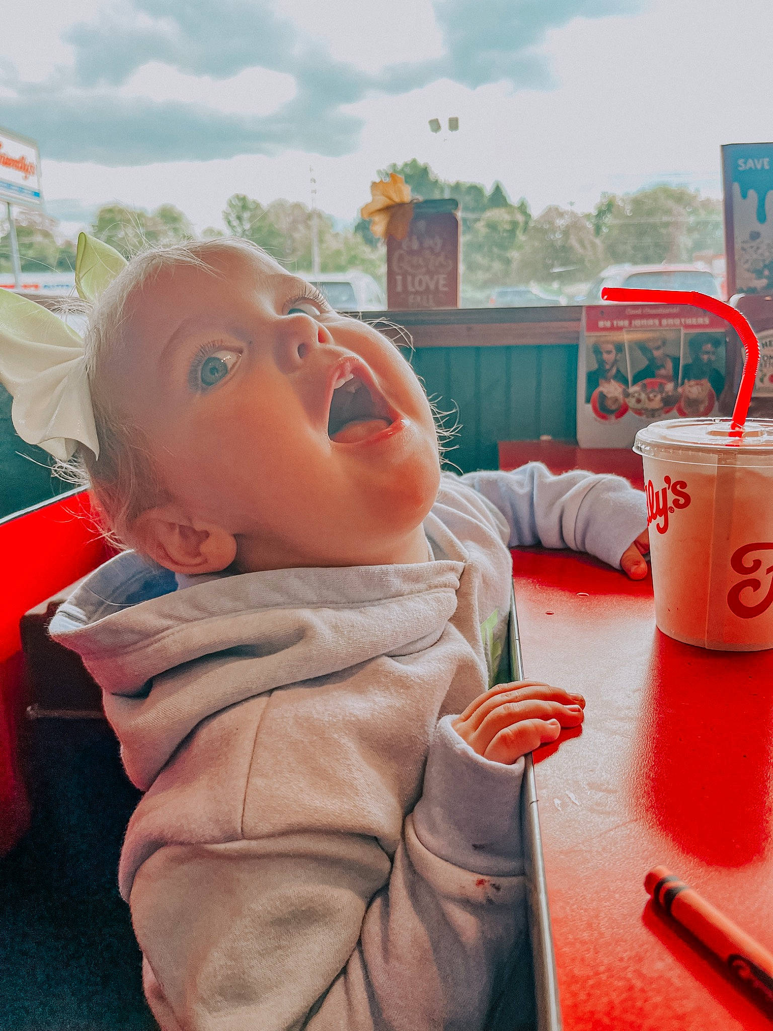 Wyllow joined the competition — help win amazing prizes! baby, child, cloud, cup, drink, drinking, drinkware, fun, happy, leisure, mug, orange, person, recreation, sitting, sky, table, tableware, toddler, toy