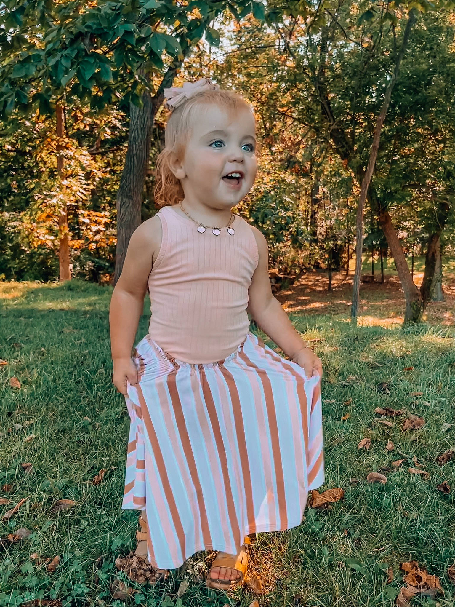 Wyllow joined the competition — help win amazing prizes! baby_toddler_clothing, blond, day_dress, dress, eye, face, grass, hair, happy, head, one_piece_garment, people_in_nature, person, plant, sleeve, smile, standing, tints_and_shades, toddler, tree