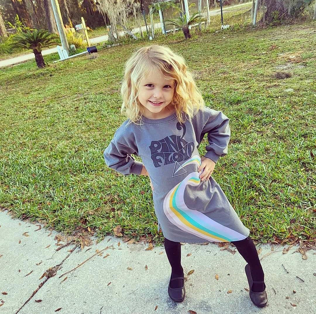 Vivian is registered to the contest to win money with this photo: active_pants, cool, fun, grass, happy, joy, knee, leaf, leg, people_in_nature, person, plant, recreation, shoe, sleeve, smile, sneakers, t_shirt, thigh, toddler