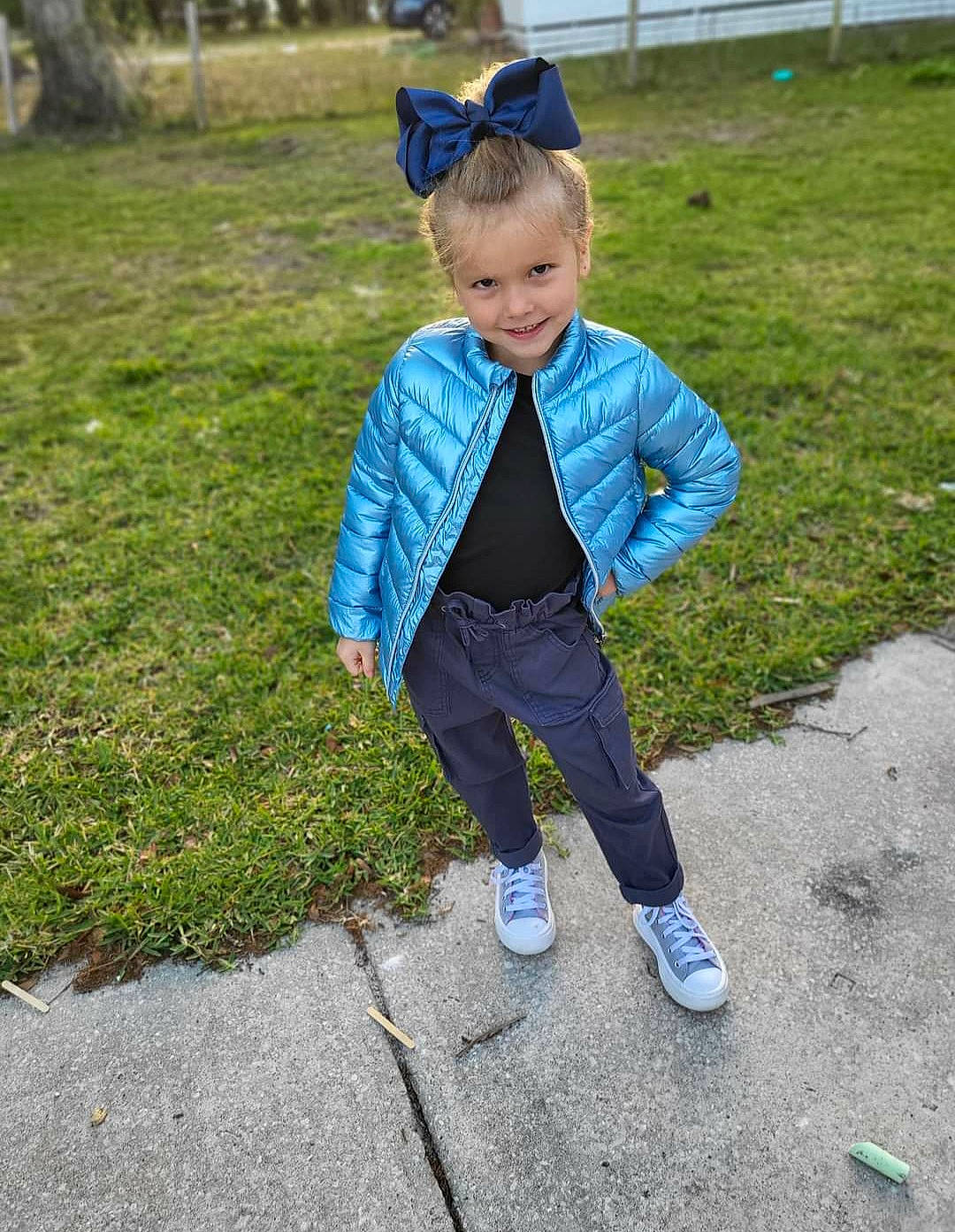 Vivian is registered to the contest to win money with this photo: baby_toddler_clothing, child, electric_blue, eye, formal_wear, fun, grass, grassland, happy, joy, lawn, leisure, people_in_nature, person, plant, recreation, sleeve, smile, soil, spring