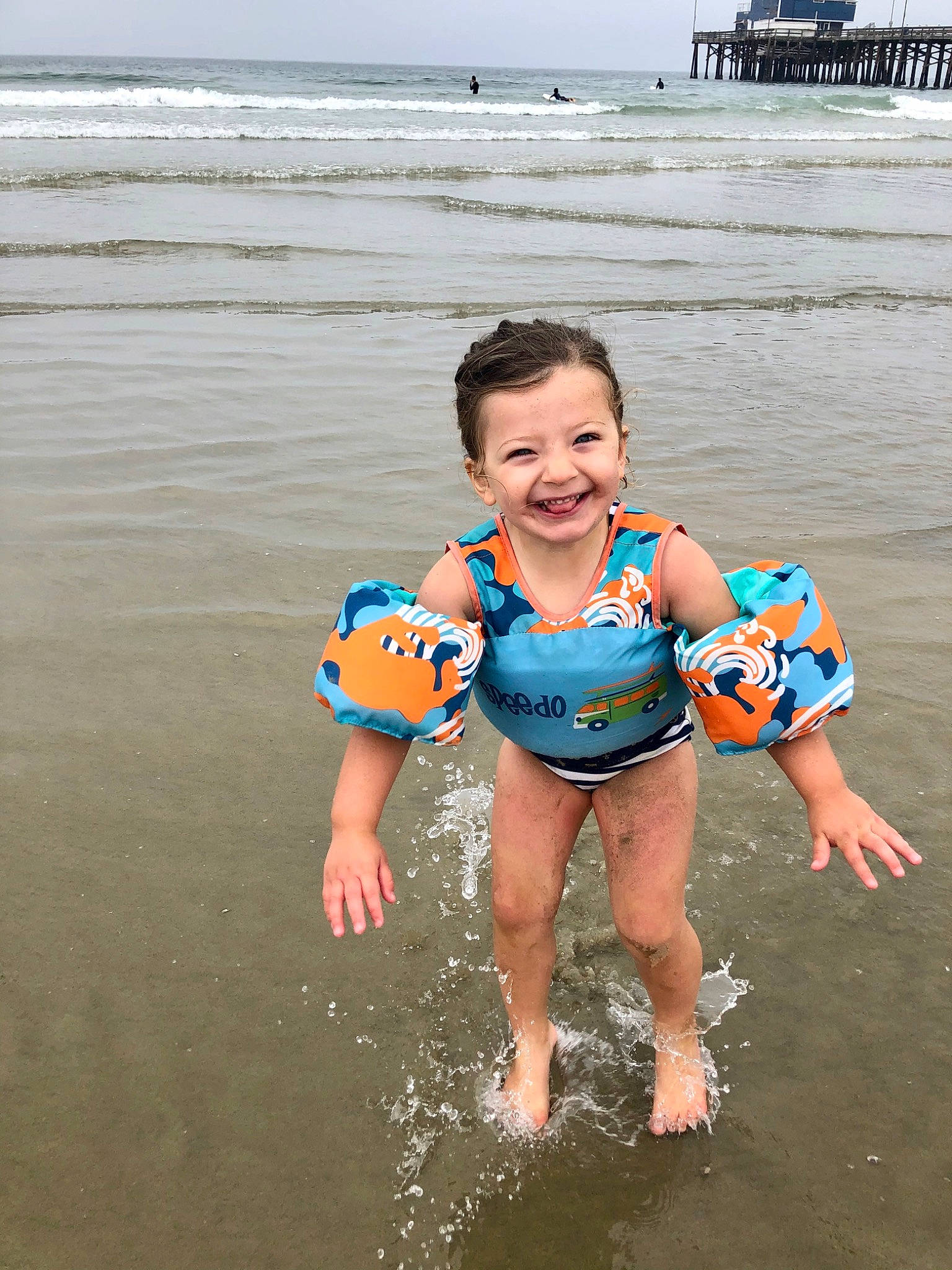 Scout is registered to the contest to win money with this photo: barefoot, beach, child, fun, joy, lifejacket, ocean, person, personal_protective_equipment, play, recreation, sea, summer, toddler, vacation, water