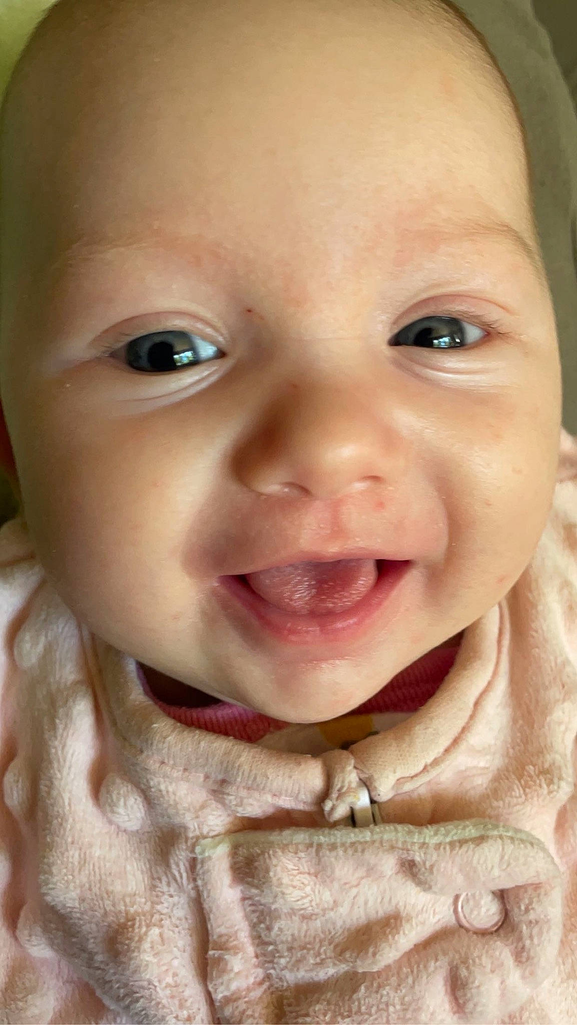 Kyra is registered to the contest to win money with this photo: baby, baby_toddler_clothing, cheek, child, chin, close_up, ear, eyebrow, eyelash, happy, iris, jaw, lip, mouth, nose, person, skin, sleeve, smile, toddler