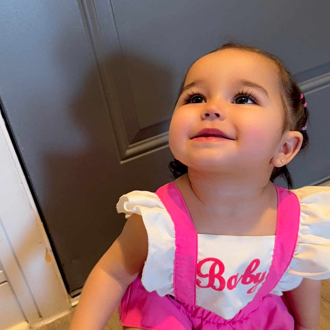 Ciel is registered to the contest to win money with this photo: baby, bodypart, clothing, door, dress, face, finger, footwear, hand, hardwood, head, indoors, person, photography, portrait, shoe, shorts, sitting, t_shirt, wood