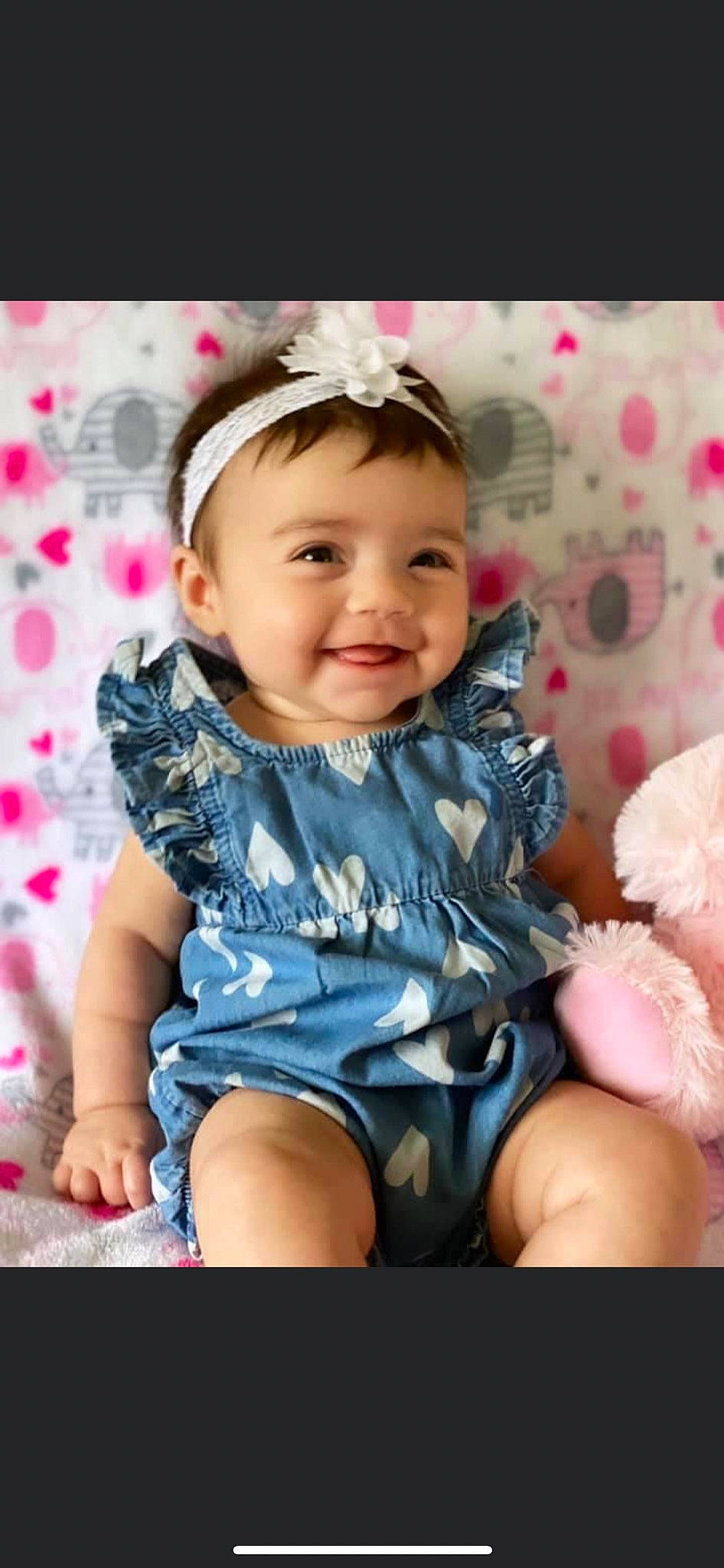 Londyn is registered to the contest to win money with this photo: baby, baby_toddler_clothing, cheek, child, dress, eye, face, facial_expression, hand, happy, iris, joy, lip, pattern, person, pink, product, skin, sleeve, smile