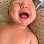 baby, bare_chest, blanket, child, closeup, cute, face, happiness, indoors, infant, joy, laughing, mouth_open, newborn, pattern, person, pillow, skin, smiling, triangle_pattern