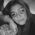 Laura E.