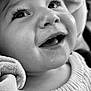baby, close_up, black_and_white, smiling, face, eyes, eyelashes, drool, beads, name_beads, fabric, clothing, portrait, child, cute, happy, infant, cozy, texture, soft