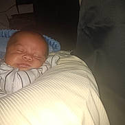 Moke is registered to the contest to win money with this photo: baby, bedding, blanket, closeup, cushion, cute, face, flash, home, indoors, infant, low_light, newborn, peaceful, pillow, portrait, resting, sleeping, sofa, striped_clothing