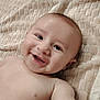 baby, smiling, infant, face, skin, blanket, texture, lying_down, happy, child, cute, portrait, eyes, mouth, expression, chubby_cheeks, bare_chest, young, indoors, soft