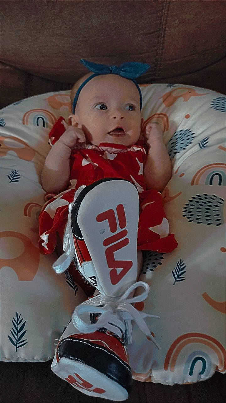 Rayne is registered to the contest to win money with this photo: baby, baby_toddler_clothing, carmine, christmas, doll, event, fictional_character, figurine, happy, holiday, person, pink, product, sleeve, souvenir, sports_jersey, textile, toddler, toy