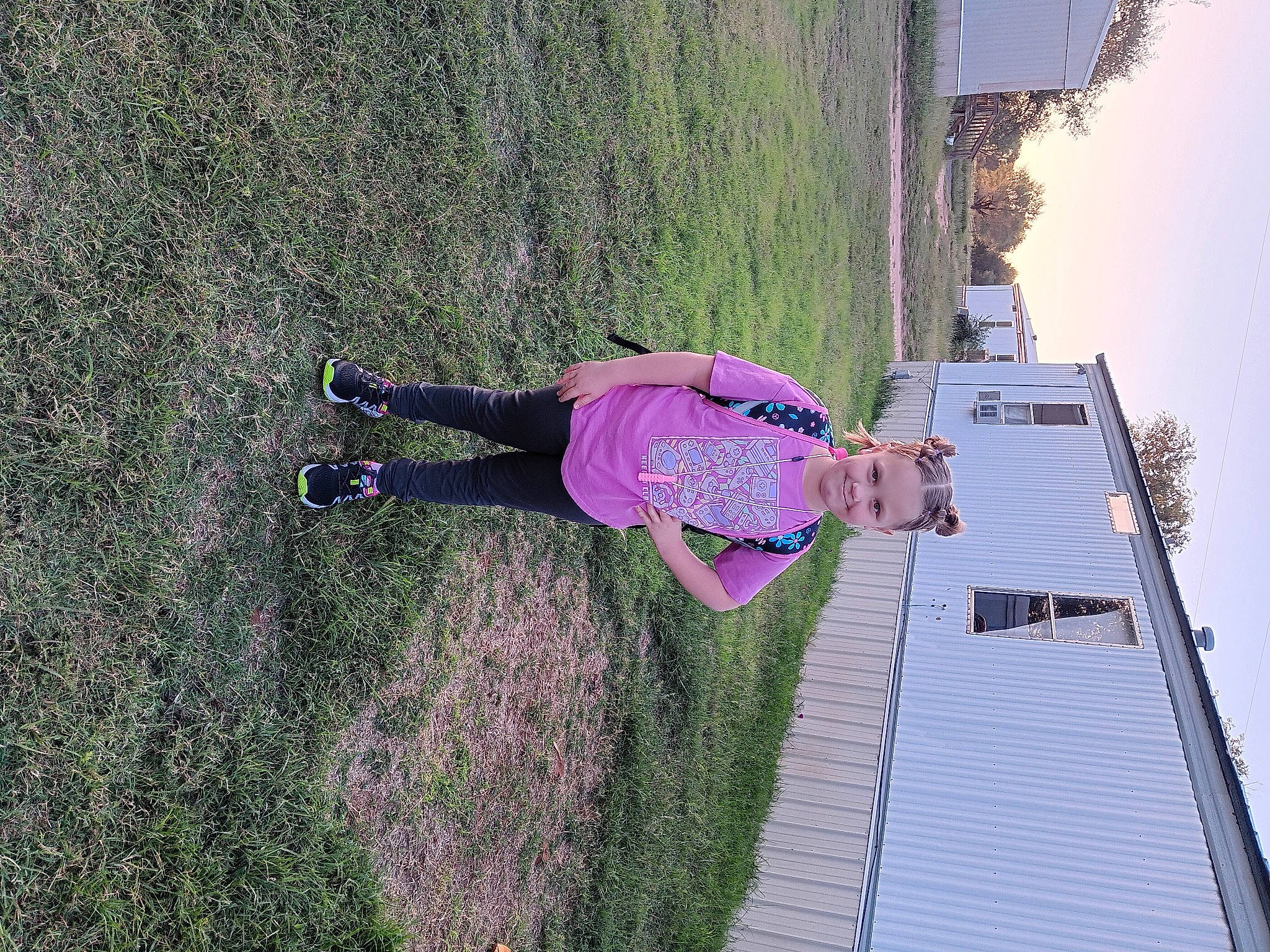 Daisy Mae Ann is registered to the contest to win money with this photo: adventure, building, facade, fun, grass, house, joy, landscape, leisure, magenta, people_in_nature, person, plant, recreation, roof, shadow, shrub, sky, slope, tree