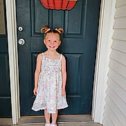 Hermonie joined the competition — help win amazing prizes! child, girl, smile, door, welcome_sign, pumpkin, hair_bows, dress, floral_pattern, sneakers, white_shoes, pink_hearts, front_porch, concrete_floor, blue_door, happy, standing, outdoor, person, home_entrance